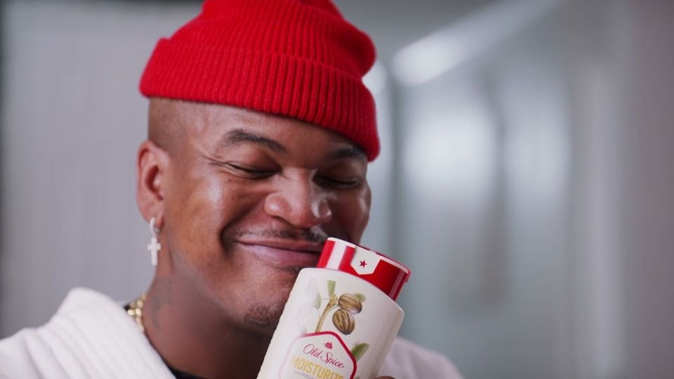 Ne-Yo holding an Old Spice bottle